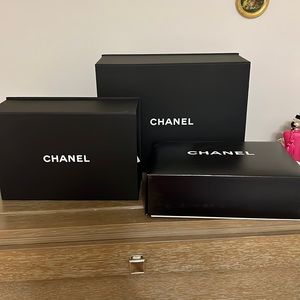 One large and two medium Chanel gift boxes.